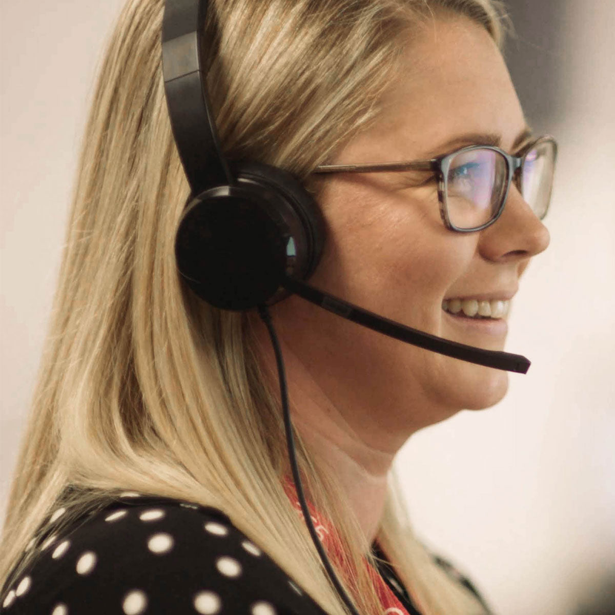 Woman wearing a headset with a blurred background