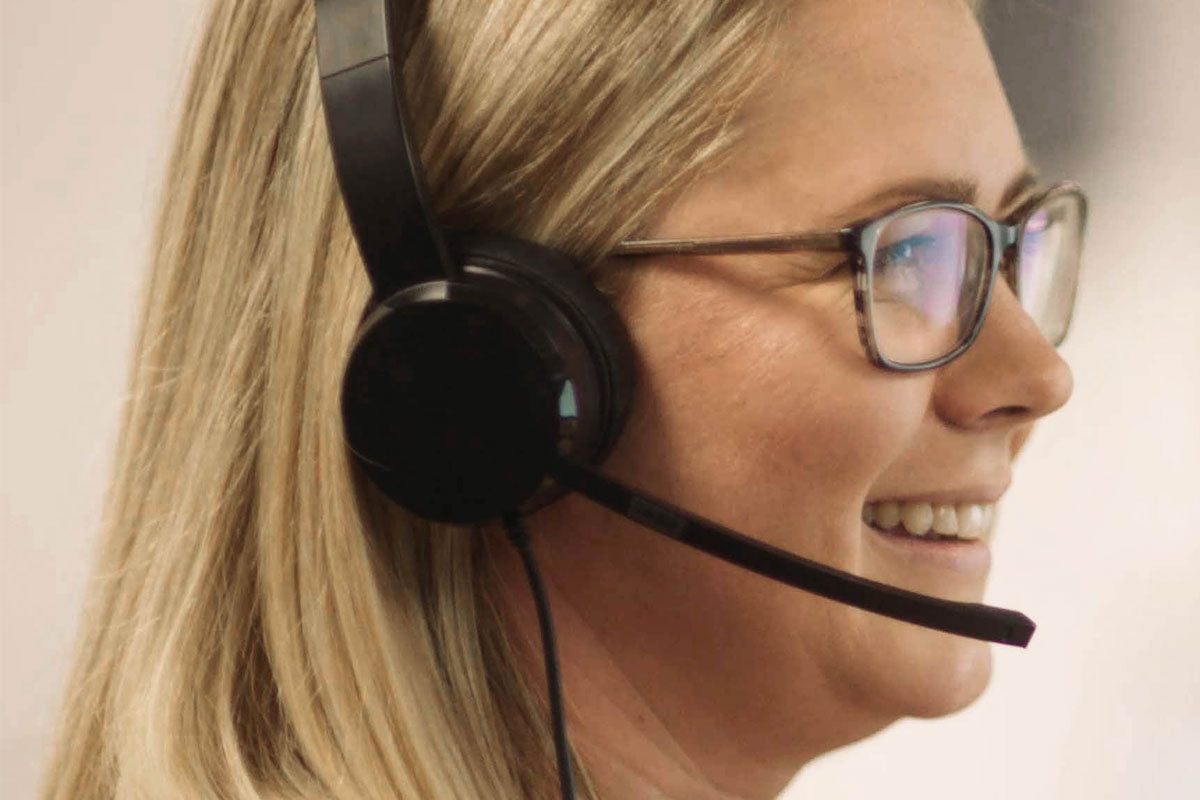 Woman from Care Team wearing a headset with a blurred background