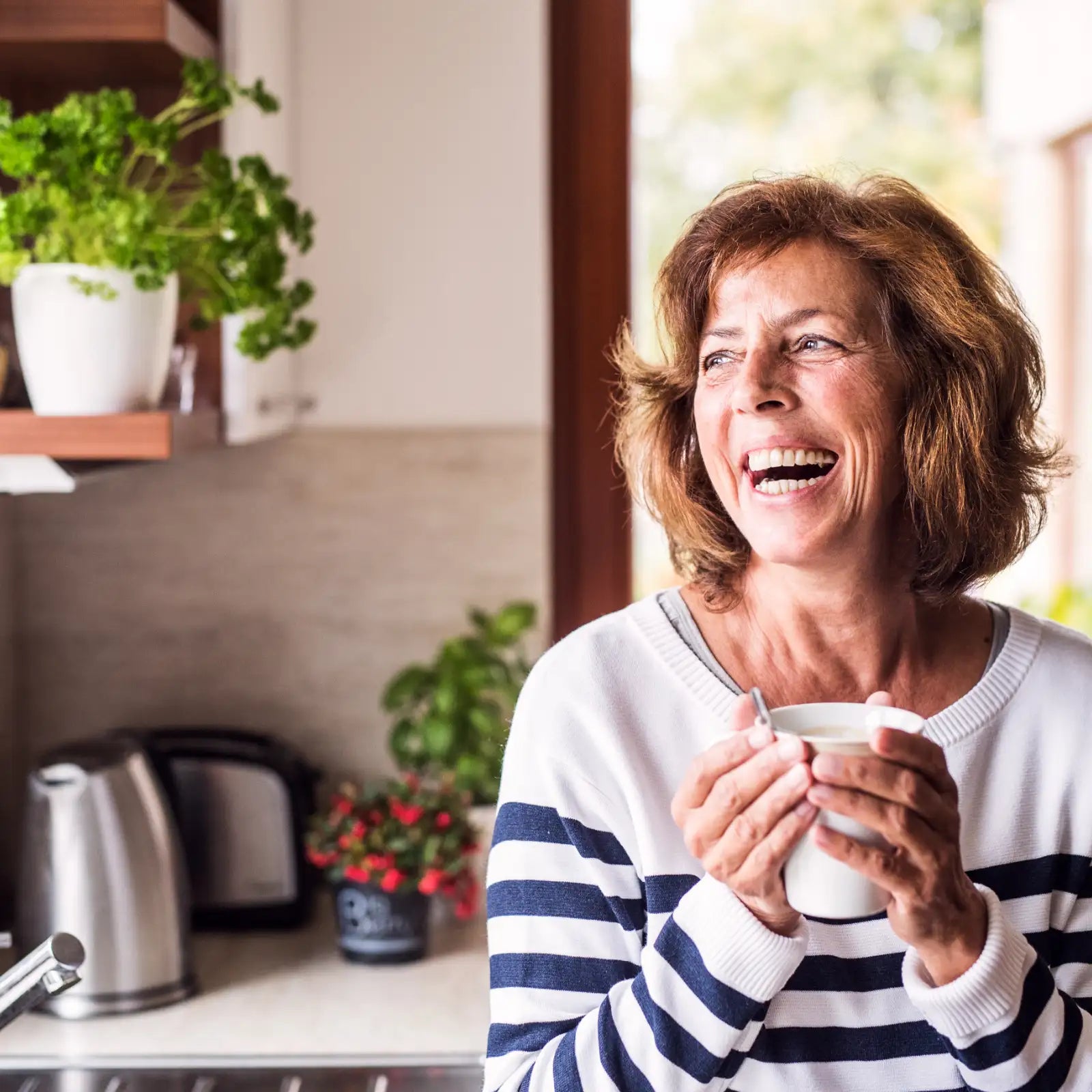 Women laughing holding a cup