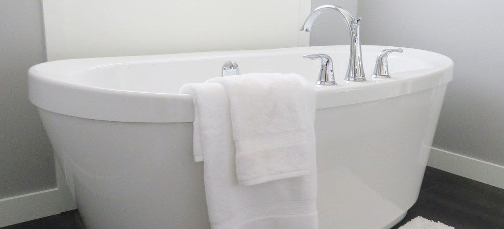 A Bathtub with a towel hanging off it