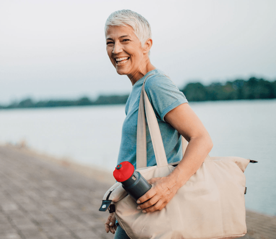 Lady walking with red drink bottle