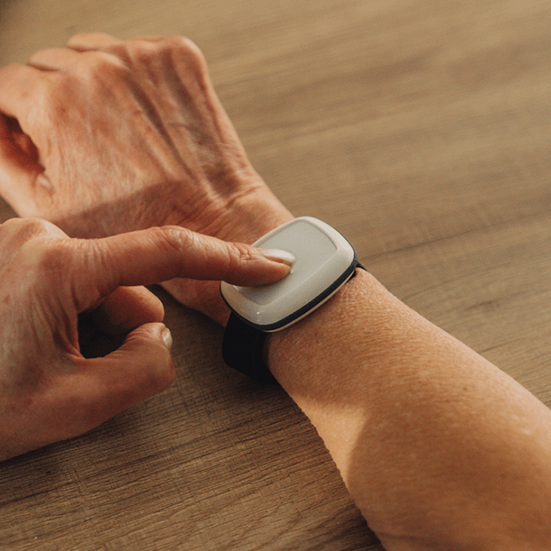 Wearing the Alarm Button on the wrist pressing the button